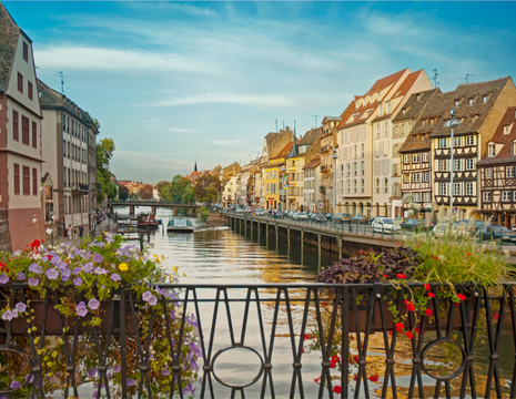 The City of Strasbourg in broad daylight on a bridge decorated with flowers