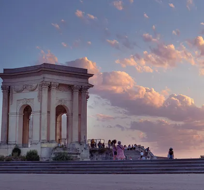 Montpellier's Arc de Triomphe, Promenade du Peyrou, sunset over the city center, exceptional living environment for professionals.