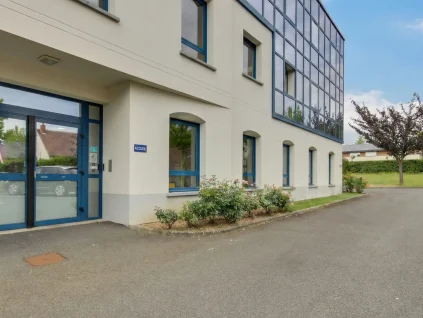 ntrée principale et façade vitrée moderne du centre d'affaires BURO Club au Mans avec parking.